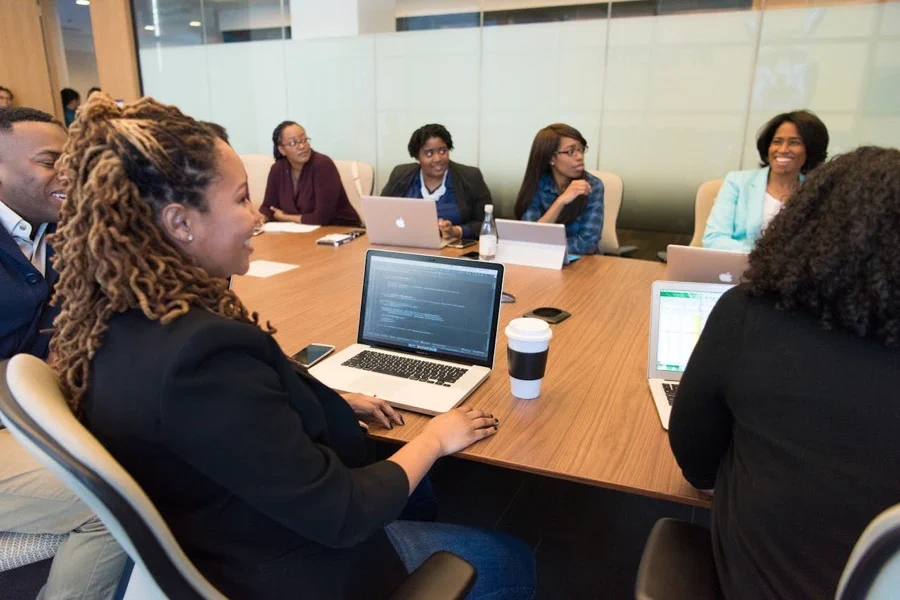 A diverse team of professionals engaged in a collaborative meeting around a conference table